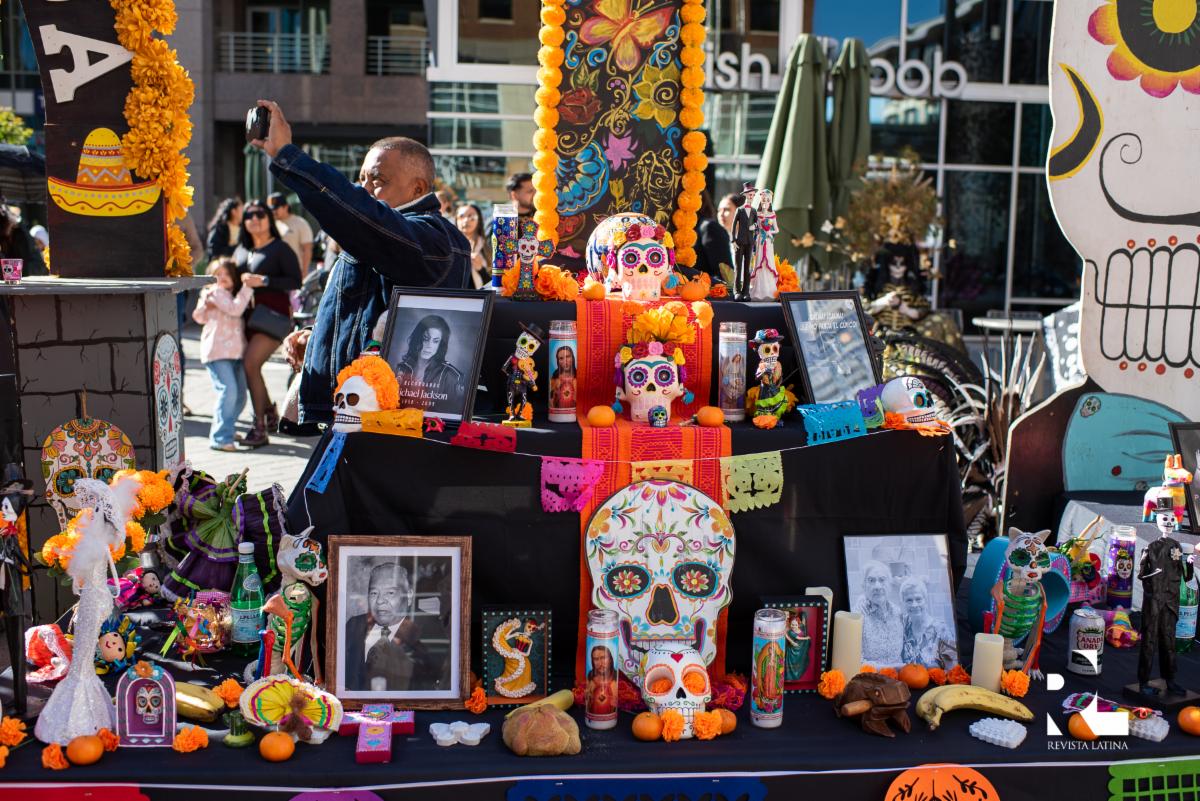 Ofrenda with marigolds, papel picado, photographs, and sugar skulls
